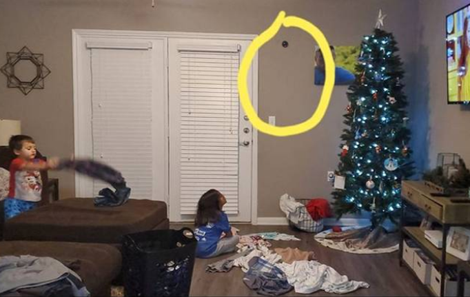 Living room, kids and Christmas tree. PixieLens Pro on the wall, above them